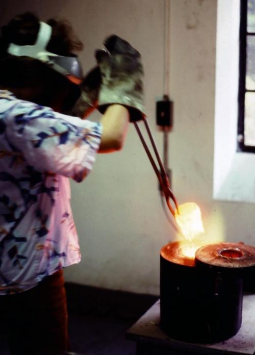 Removing a crucible of molten silver from the blast furnace.