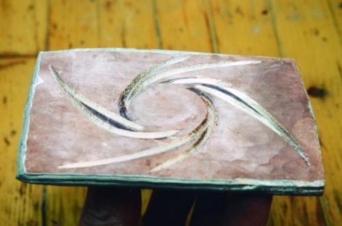 A spiral pattern is carved into the internal layers of the sheet.