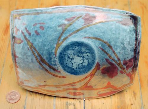 The carved spiral pattern is hammered smooth, and the circular base of the bowl is established.