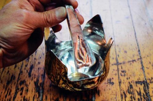 In 2010, I used the strip of mokume that had been cut from the original sheet to fashion a handle for the Rose Bowl. Here, a woodgrain pattern for the handle is being established.