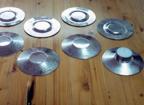 Early stages of raising: the four holders in the back have been just begun, and the four in front are shown after one complete "course" of raising (the entire surface worked).