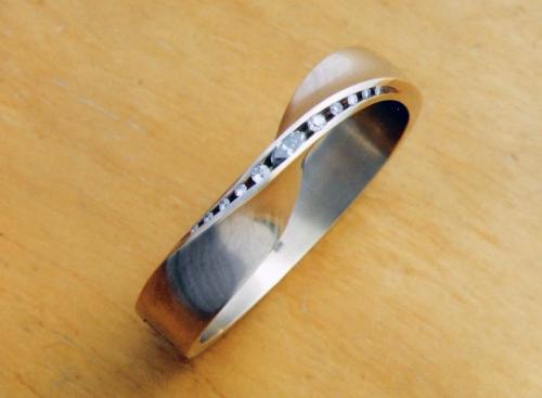 The finished bracelet. The ends of the hinge rivets are filed flush to the surface, and the entire piece is given a bright satin finish.