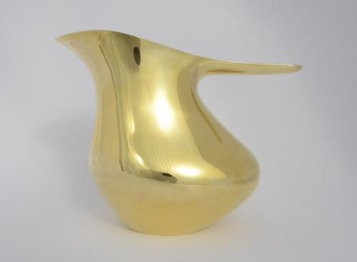 The finished piece showing how much more the front area is brought in and raised higher. The entire piece is planished smooth using nearly flat-faced hammers and literally "ironing" the brass between conforming steel surfaces. The planished piece is now work-hardened and very strong. The entire surface is filed and polished to a mirror-like shine.