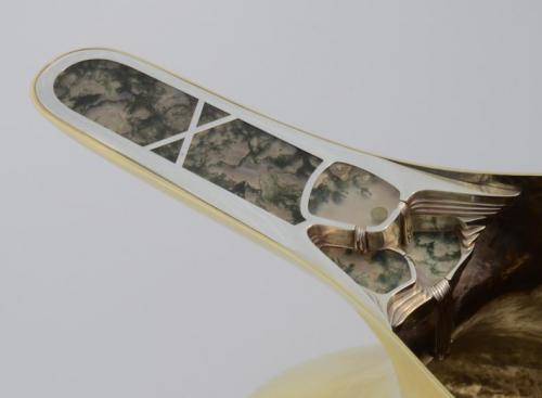 The finished handle with a "landscape" built up of layers of sterling sheet and set with 7 moss agates. The entire sterling unit is secured both by being riveted to the brass handle below and by being bezel-set along its edges.