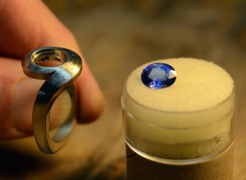 The metal within the stone setting is accurately carved to “seat” the stone, and the rim is undercut to allow the metal to fold / flow just over the edge of the stone.