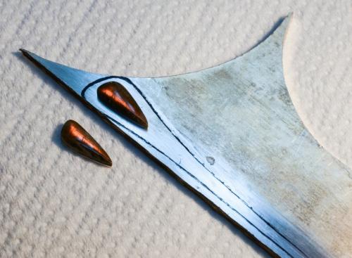 Because labradorite cleaves easily, the back of the stones themselves are glued to a layer of sterling. The raw materials are: the sterling-backed orange labradorites, and a 3mm. thick sheet of sterling silver.
