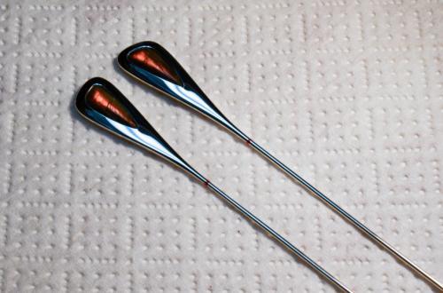 The final shape and dimensions are sculpted back and polished while the earrings are straight. A small amount of hammering partly work-hardens the area on each earring that will become the crook-shaped wire.