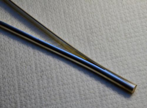 A heavy round wire is cut in half most of the way down its length.