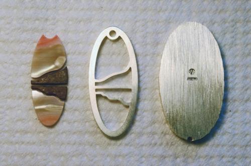 The selected areas of shell and wood are precisely shaped to fit the framework. All edges of the inlay pieces are slightly beveled (tapered in a bit toward the visible surface).
