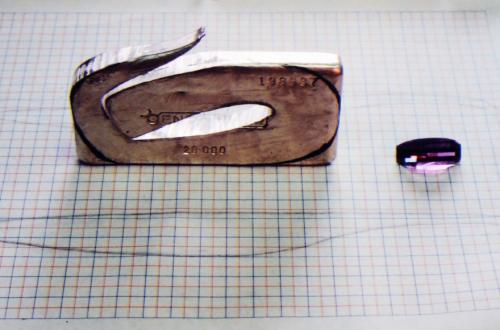 The ingot is cut and the process of unfurling a rod from within begins.