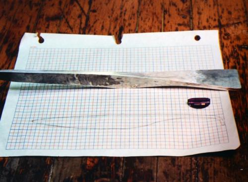 Using shaped hammers to give directional flow, the letter opener handle is forged considerably wider, and the blade is about to be forged more vertically.