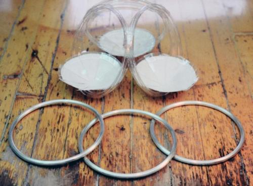 The three circles of heavy sterling wire, and a plastic mockup of the design.