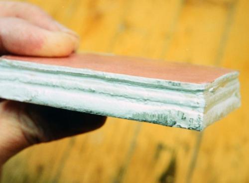 The edges of the stack have been coated with solder, and the forging process has begun.