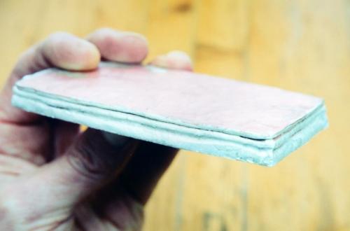 WIth repeated hammering and annealing, the stack is now about half its original thickness.