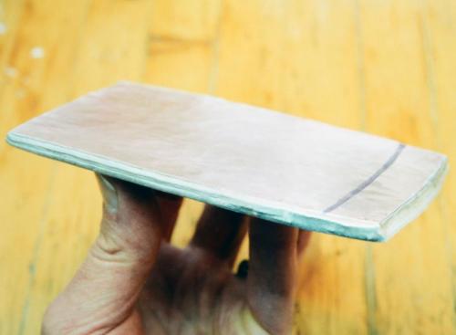 The mokume stack forged out to a rectangular sheet about 6 mm. thick. The rectangle was cut along the black line to make the sheet closer to a square.