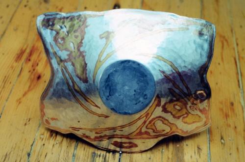 Additional pattern is carved and hammered smooth. Areas of de-lamination along the edges are trimmed off.