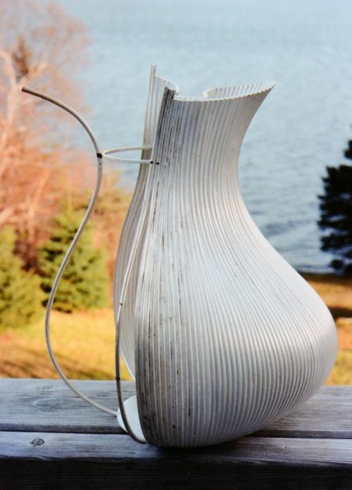 This photo (and the previous photo) shows how a single wire is soldered at the bottom and near the top, then another wire will divide that gap and be soldered top and bottom, then two more sliver-like wires will be soldered in to fill the two remaining spaces.