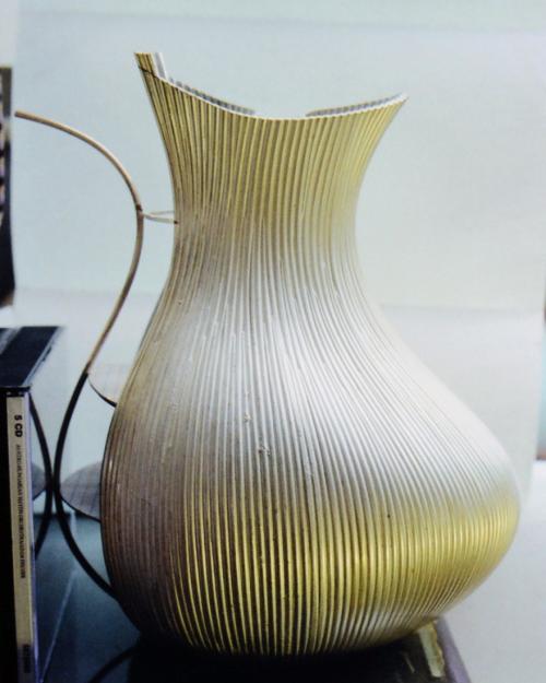 Both sides of the pitcher are now constructed the same distance around. Cardboard templates (not shown) are used throughout the process to maintain symmetry.