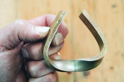 The ends of the propeller shape are being bent around toward one another.
