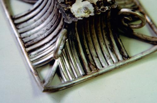 This detail photo of the bottom roof shows how the wires are set into the framework. The five shiny wires toward the lower left corner are ready to be soldered. Each wire is fit such that it locks in place to be soldered.