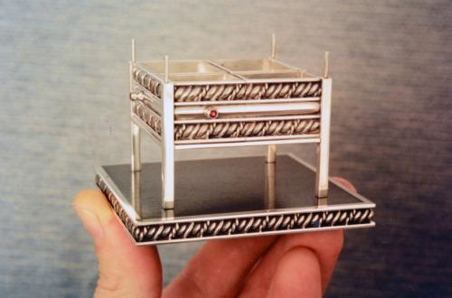 The ebony base attached to the bottom layer with its ruby-handled drawers temporarily in place.