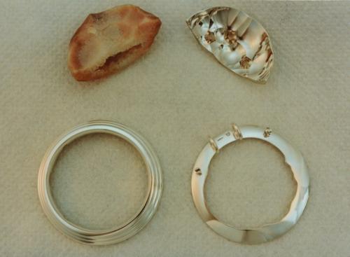 The four components are seen here (clockwise from the upper left): the half geode; the sterling half with three topaz; the conforming collar; and the circular framework. All are pre-polished and ready for setting.