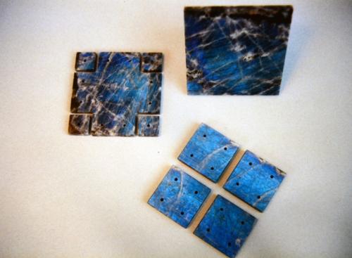 This shows all ten labradorite panels. Each has been precisely cut and polished and, with the exception of the base, drilled.