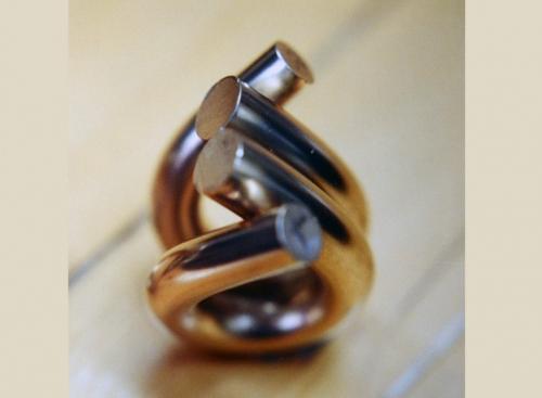 Two halves bent fully around. The surfaces shown in contact will then be faced off half way through.
