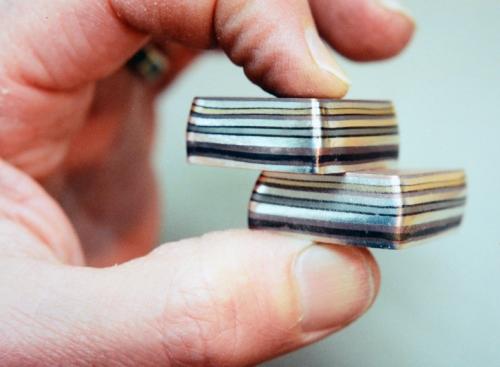 The fused stacks. The edges are filed flush, and the contrasting colours of the metals are temporarily enhanced by being patined in ammonia fumes.