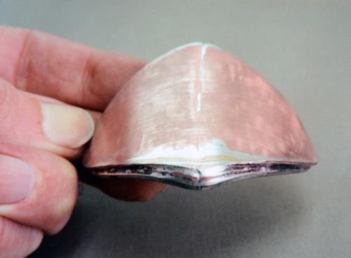 The resulting unit is bent into an arc like the contour of part of a hollow tree.