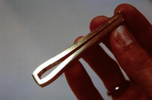 The gold rod, mitered, bent and soldered so as to create the square-ended shape that will eventually receive the stone.