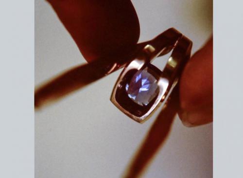 The tanzanite is seen precisely fit into the ring from the back. Care is taken to accurately "seat" the upper edges of the stone so that they are flush to the metal without pressure points or without any effect the stone "teeter-tottering."