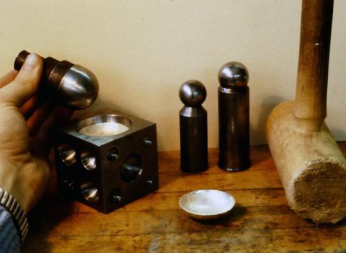 The two sterling circles are hammered into the block to make two hemispherical shapes.