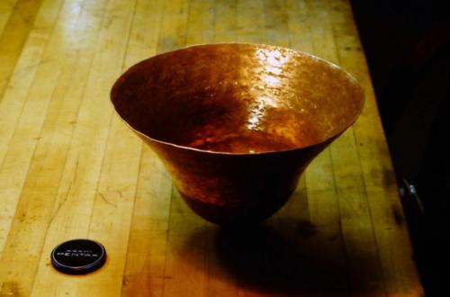 About 15 courses. The rounded, bulb-like shape of the vase is well established. The raising now begins primarily from where the shiny hammer marks can be seen in this photo.