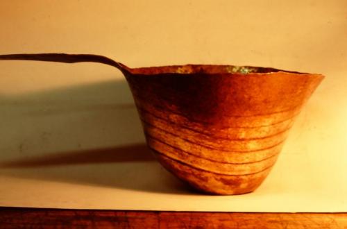 About 22 courses. While smithing the area under the handle, the angle of the metal to the steel stake is increased, while the angle of raising under the spout area is slightly decreased. This results in an asymmetrical shape.