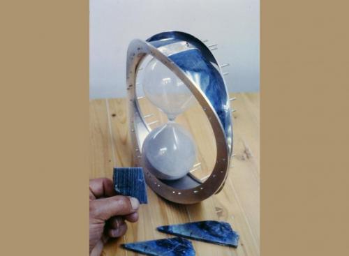 The "twinning" variety of labradorite is seen in this photo. Two squares of labradorite have yet to be created (from the slice I am holding) to fit on either side of the yin-yang.