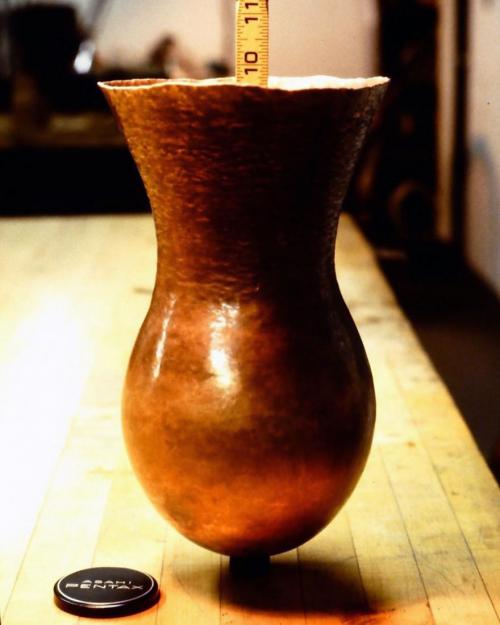 About 33 courses, and a depth approaching 10." The bulb-shape of the vase has been planished smooth where the form is no longer being altered.