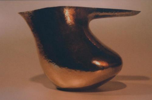 Now the trough-like shape of the handle is established, and the front area below the spout is being raised up and in.