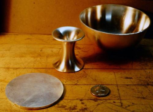 The new ingot is rolled to a 1/8" thickness and a disc is cut out.