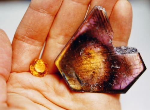 The polished labradorite showing the halo of orange iridescence within the purple, and a faceted yellow citrine that will become the brilliant "sun."
