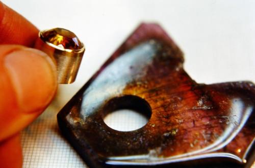 The citrine is now set in its yellow gold bezel. All tool marks have been filed off and the gold is polished. The outer cylinder shape is ever-so-slightly tapered, widest at its bottom and narrowest at the gold bezel. The hole in the labradorite is similarly tapered. When inserted from the back of the labradorite, therefore, the cylinder precisely presses into place and cannot go further through. A small amount of epoxy "locks" the parts together. The bottom of the cylinder is flush with the back of the lab