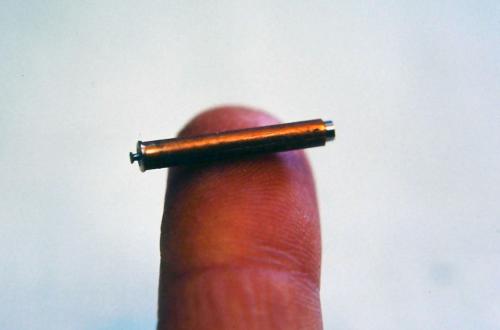 The process for setting the stone is one that I have figured out for myself (it may be common practice, but I devised it to meet my own desire to create clean stone settings with a feeling of thickness and substance to the metal surrounding the stone). I call it an "undercut bezel." The process involves customizing a tool. Here a small stone-setting burr has been tightly fit into a length of brass tubing. Most of the burr's pointed tip has been stoned off which renders the sharp outer edge of the burr like 